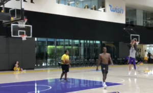 A group of men playing basketball on the court.