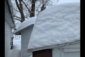 A snowy roof on top of a house.