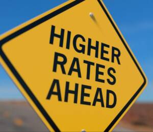 A yellow sign that says higher rates ahead.